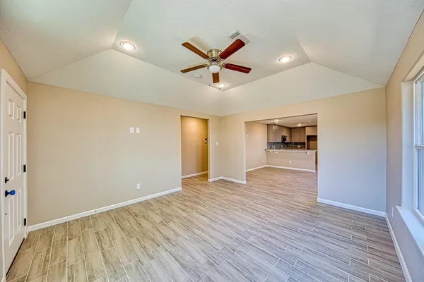 wooden floor in an empty room with a window