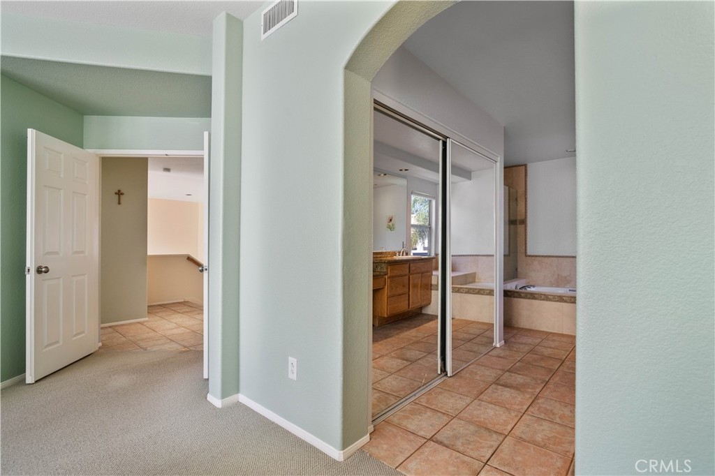 1147 Rosemary Circle Corona, CA 92879 - Photo 15 of 32 a bathroom with a glass door shower