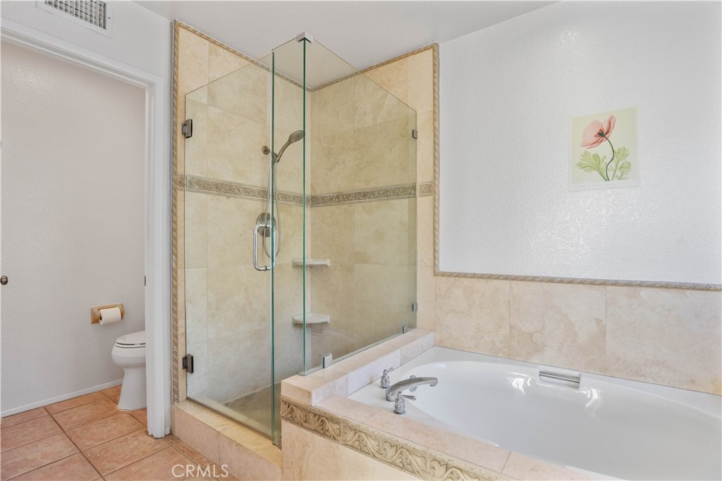 1147 Rosemary Circle Corona, CA 92879 - Photo 19 of 32 a bathroom with a tub and shower