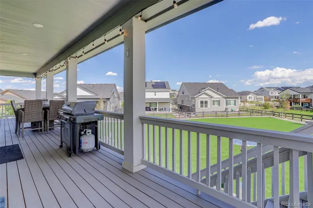 a view of a deck with wooden floor and city view