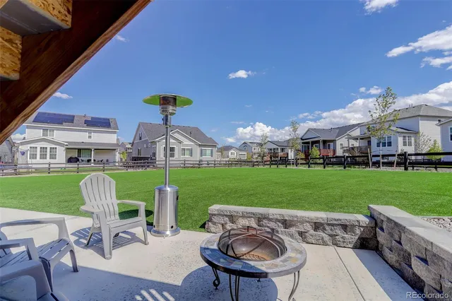 a front view of a house with a garden and outdoor seating