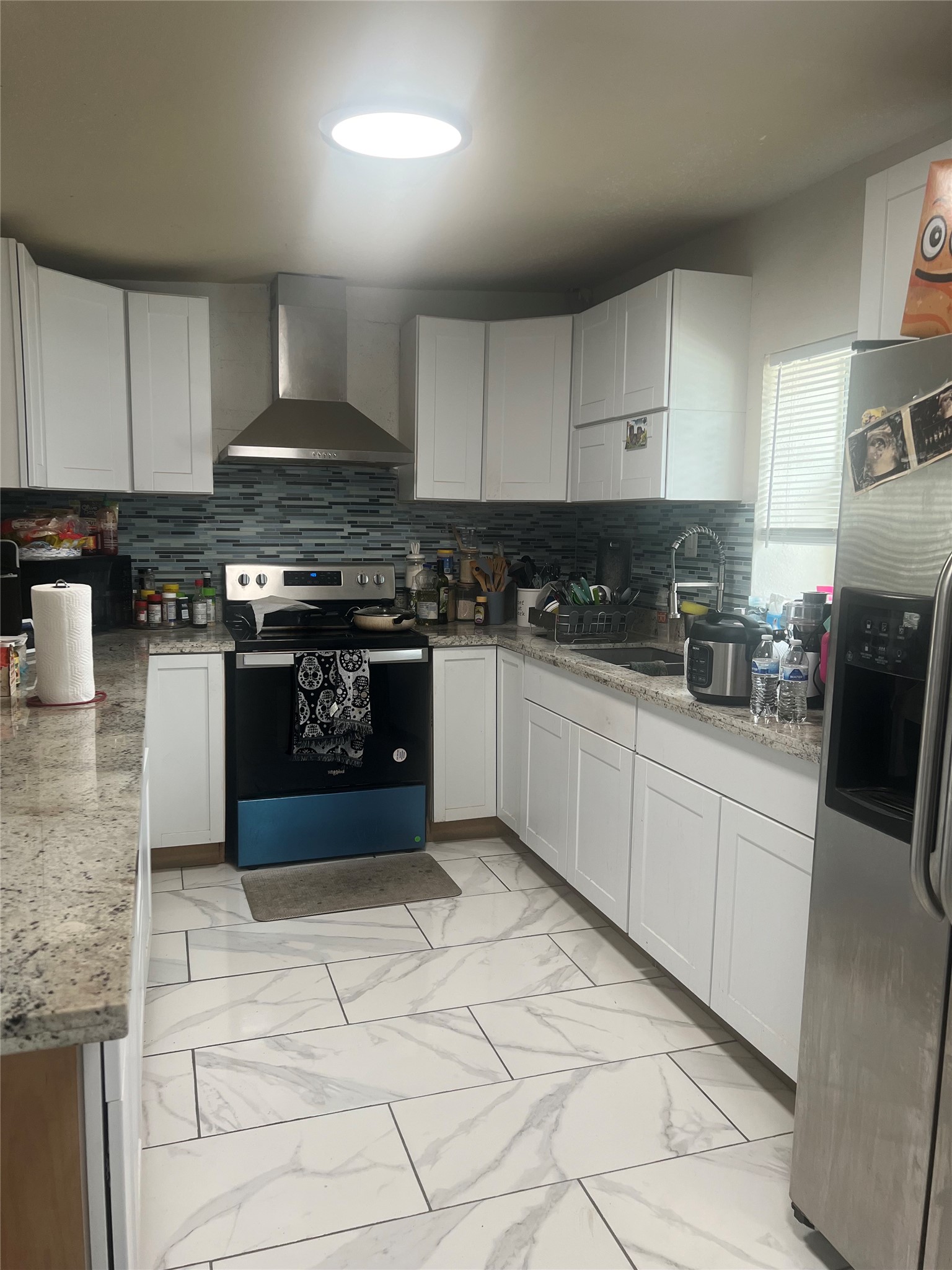 22360 East Martin Drive Porter, TX 77365 - Photo 4 of 10 a kitchen with stainless steel appliances granite countertop a stove a sink and a granite counter tops