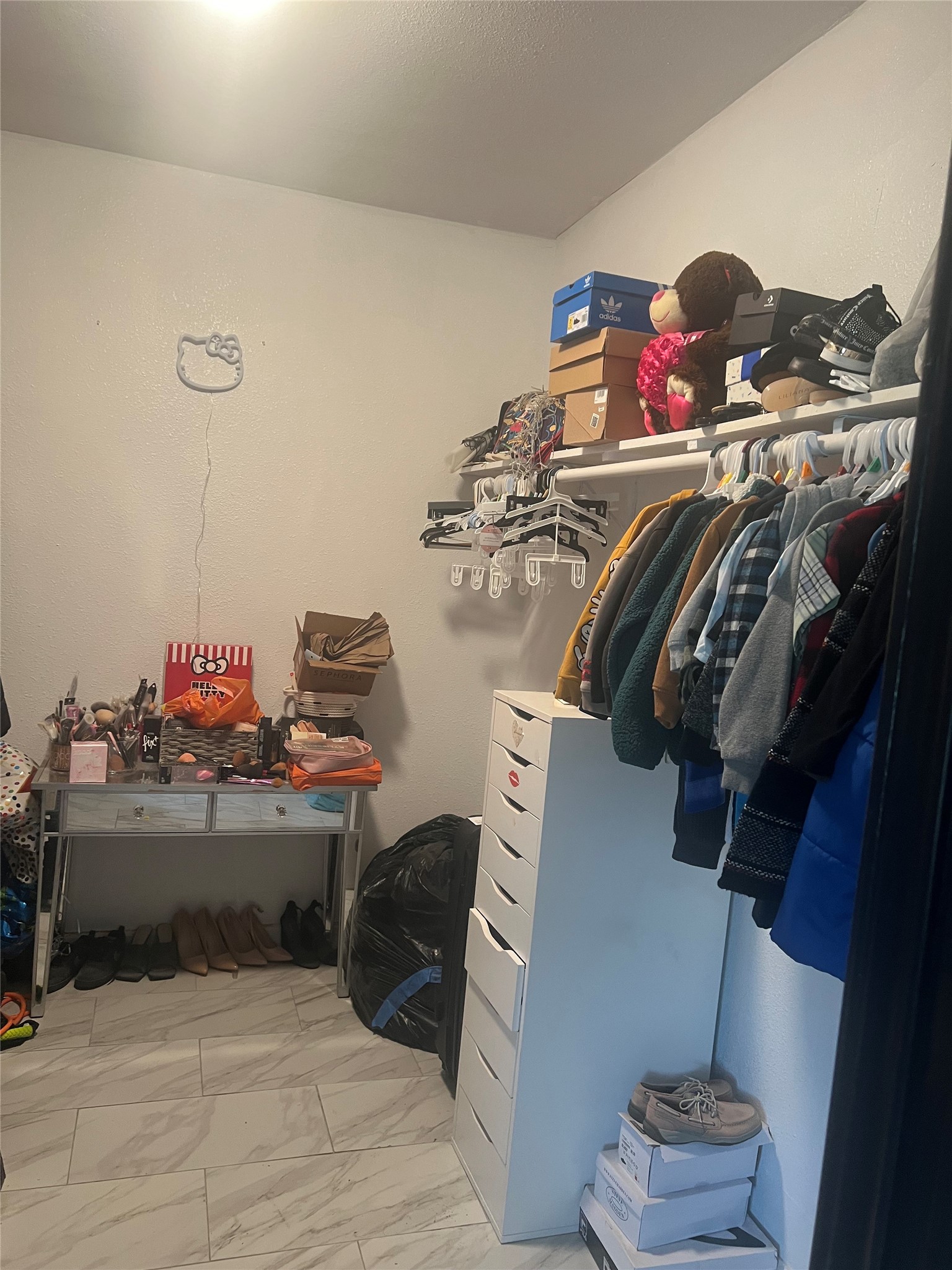 22360 East Martin Drive Porter, TX 77365 - Photo 8 of 10 a view of walk in closet with clothes and shoes