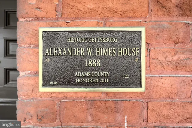 a view of entryway livingroom and hall with wooden floor