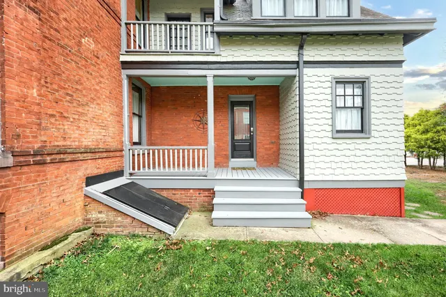 a kitchen with granite countertop white cabinets and window