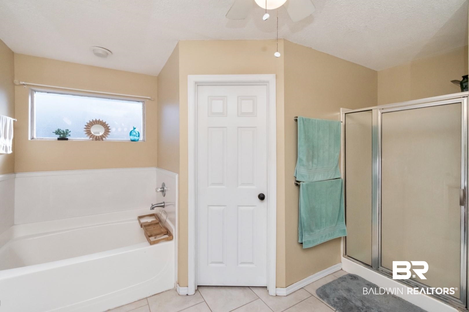 29221 Canterbury Road Daphne, AL 36526 - Photo 13 of 17 Bathroom with tile patterned floors, ceiling fan, plus walk in shower, and a textured ceiling