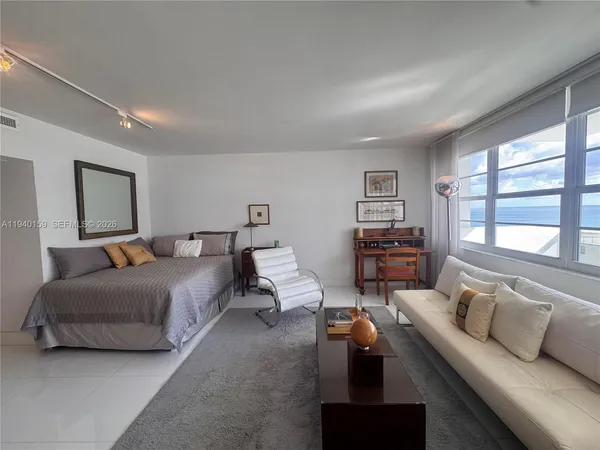 a kitchen with stainless steel appliances a sink a stove a microwave a refrigerator and cabinets