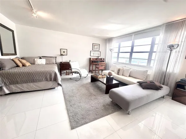 a spacious bedroom with a bed and couch