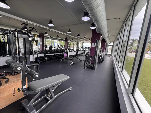 a room with lots of furniture and gym equipment