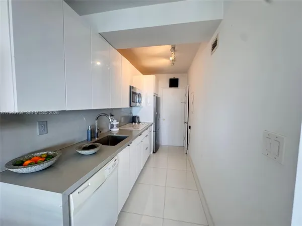 a kitchen with a refrigerator and a sink