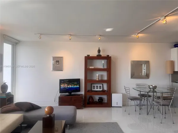 a living room with furniture a table and a flat screen tv