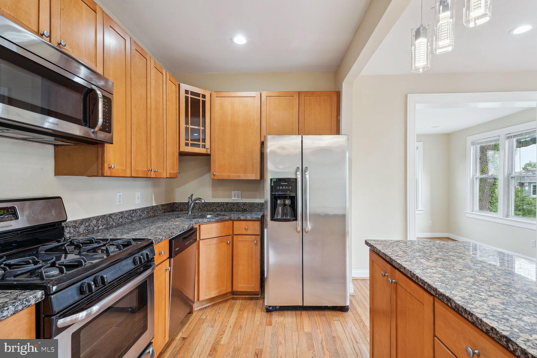 4528 4th Street Northwest Washington, DC 20011 - Photo 9 of 28 a kitchen with granite countertop a sink cabinets and stainless steel appliances