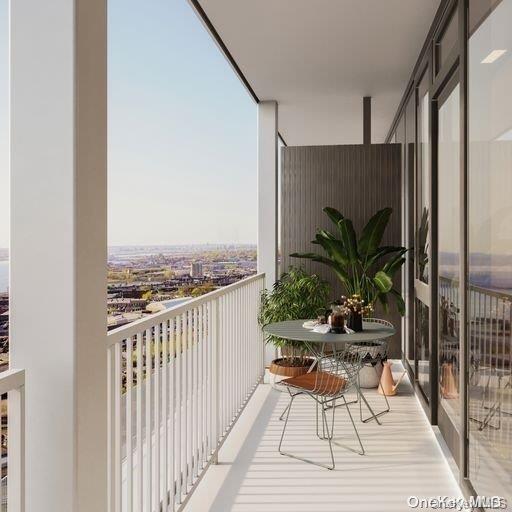 131-02 40th Road, Unit 5G Queens, NY 11354 - Photo 26 of 32 a view of a balcony with chairs and wooden floor