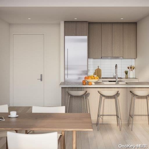 131-02 40th Road, Unit 5G Queens, NY 11354 - Photo 28 of 32 a kitchen with stainless steel appliances granite countertop a sink a stove a refrigerator and white cabinets