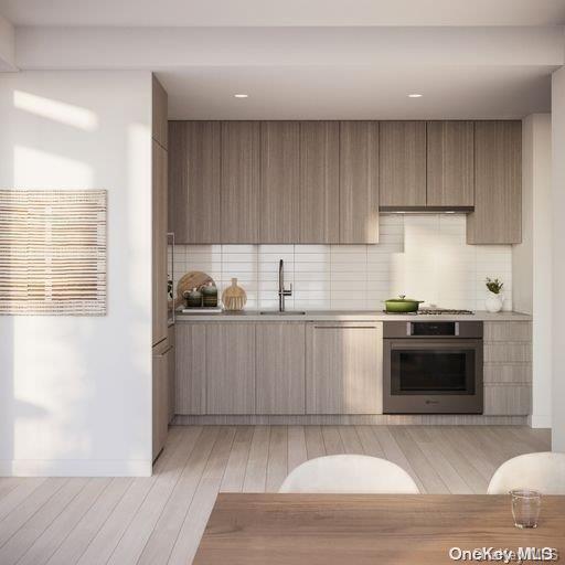 131-02 40th Road, Unit 5G Queens, NY 11354 - Photo 29 of 32 a kitchen with a sink and a stove top oven