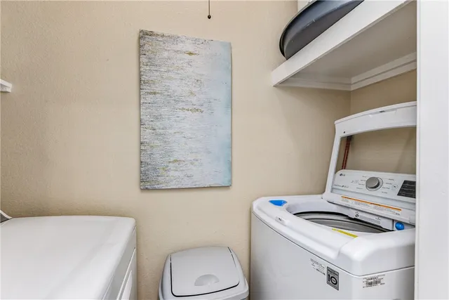 a view of a balcony with chair and wooden fence