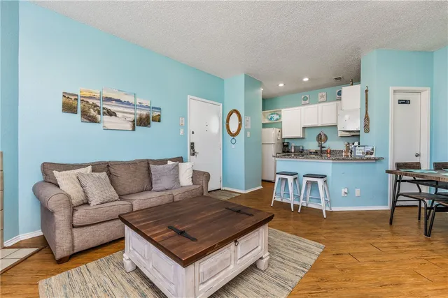 a living room with furniture and kitchen view