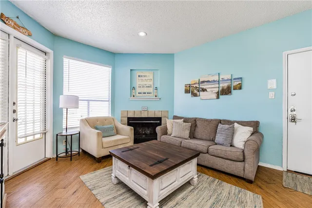 a living room with furniture and a potted plant next to a window