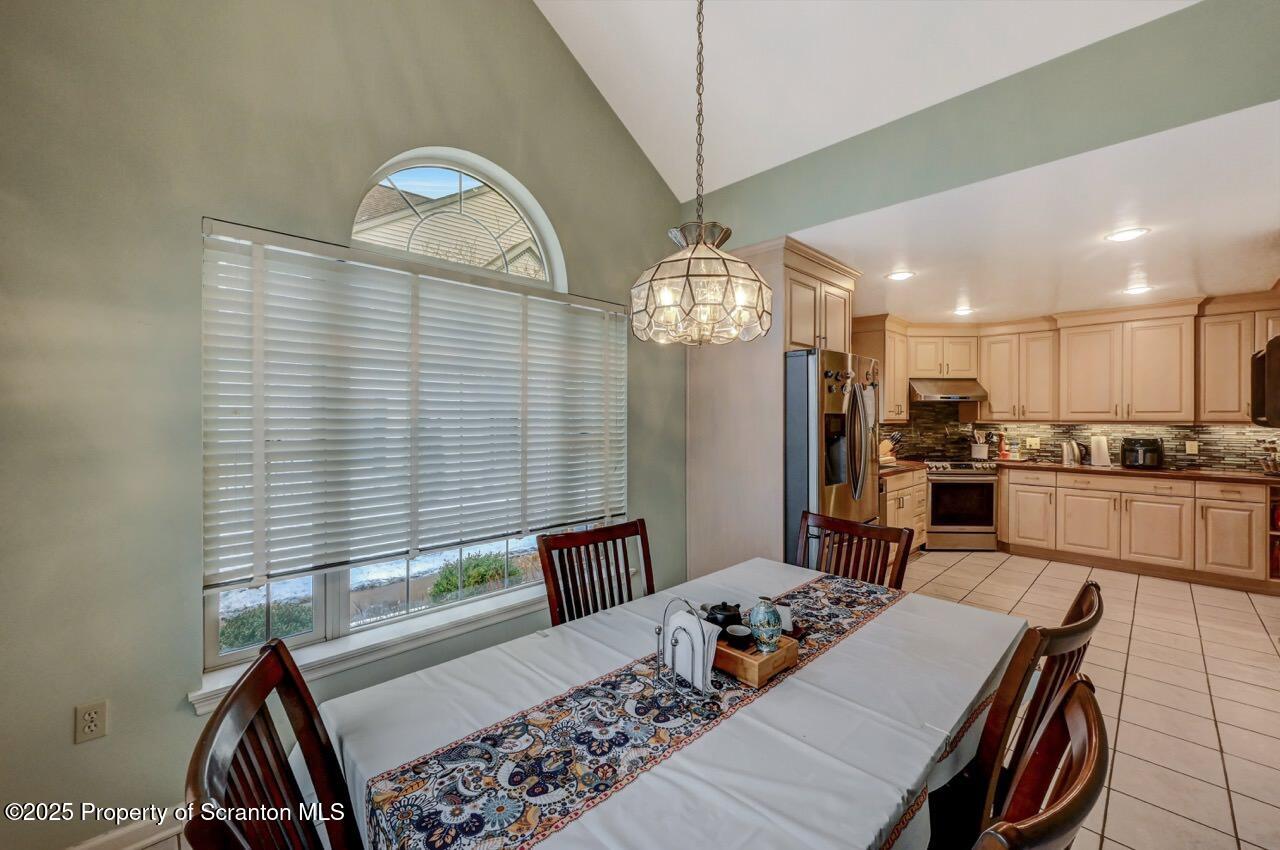 20 Hedge Row Run Clarks Summit, PA 18411 - Photo 14 of 66 a open kitchen with stainless steel appliances granite countertop a stove top oven a dining table and chairs with wooden floor