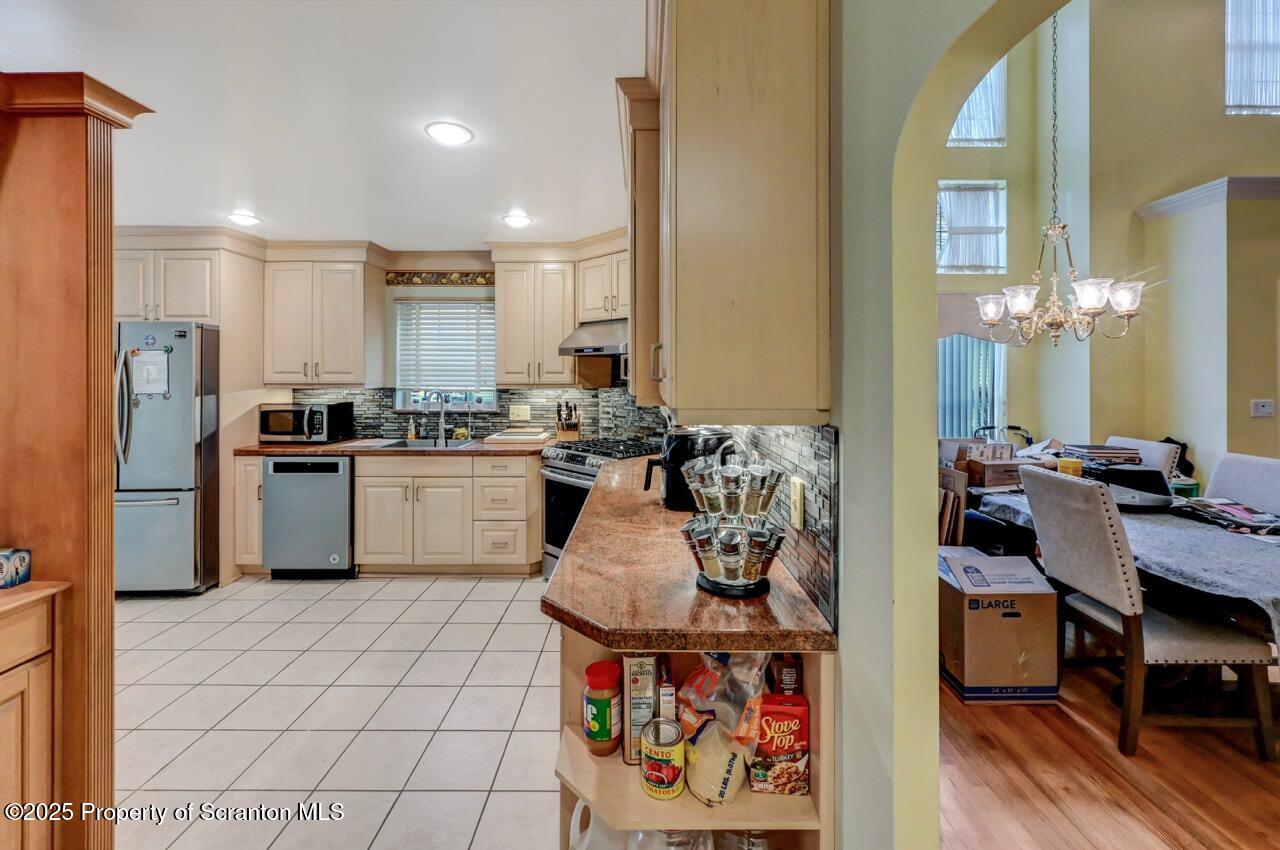 20 Hedge Row Run Clarks Summit, PA 18411 - Photo 19 of 66 a kitchen with stainless steel appliances a sink a stove a refrigerator cabinets and dining table