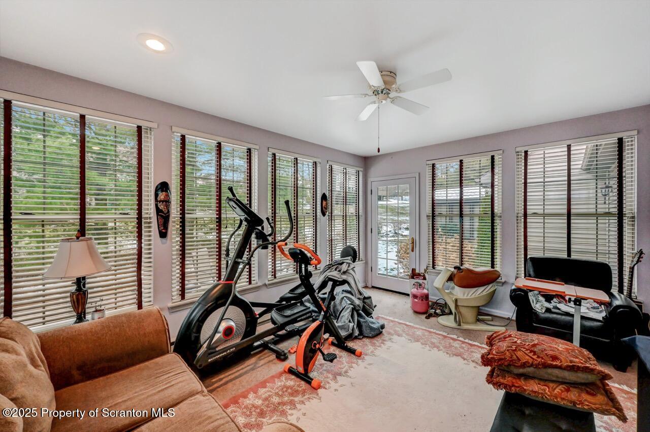 20 Hedge Row Run Clarks Summit, PA 18411 - Photo 22 of 66 a living room with furniture floor to ceiling window and a flat screen tv
