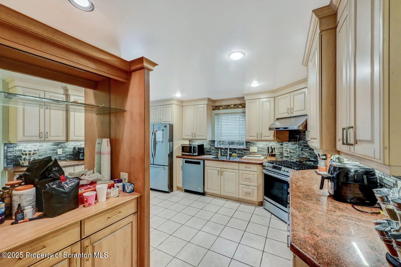 20 Hedge Row Run Clarks Summit, PA 18411 - Photo 37 of 66 a kitchen with stainless steel appliances granite countertop a sink stove and refrigerator