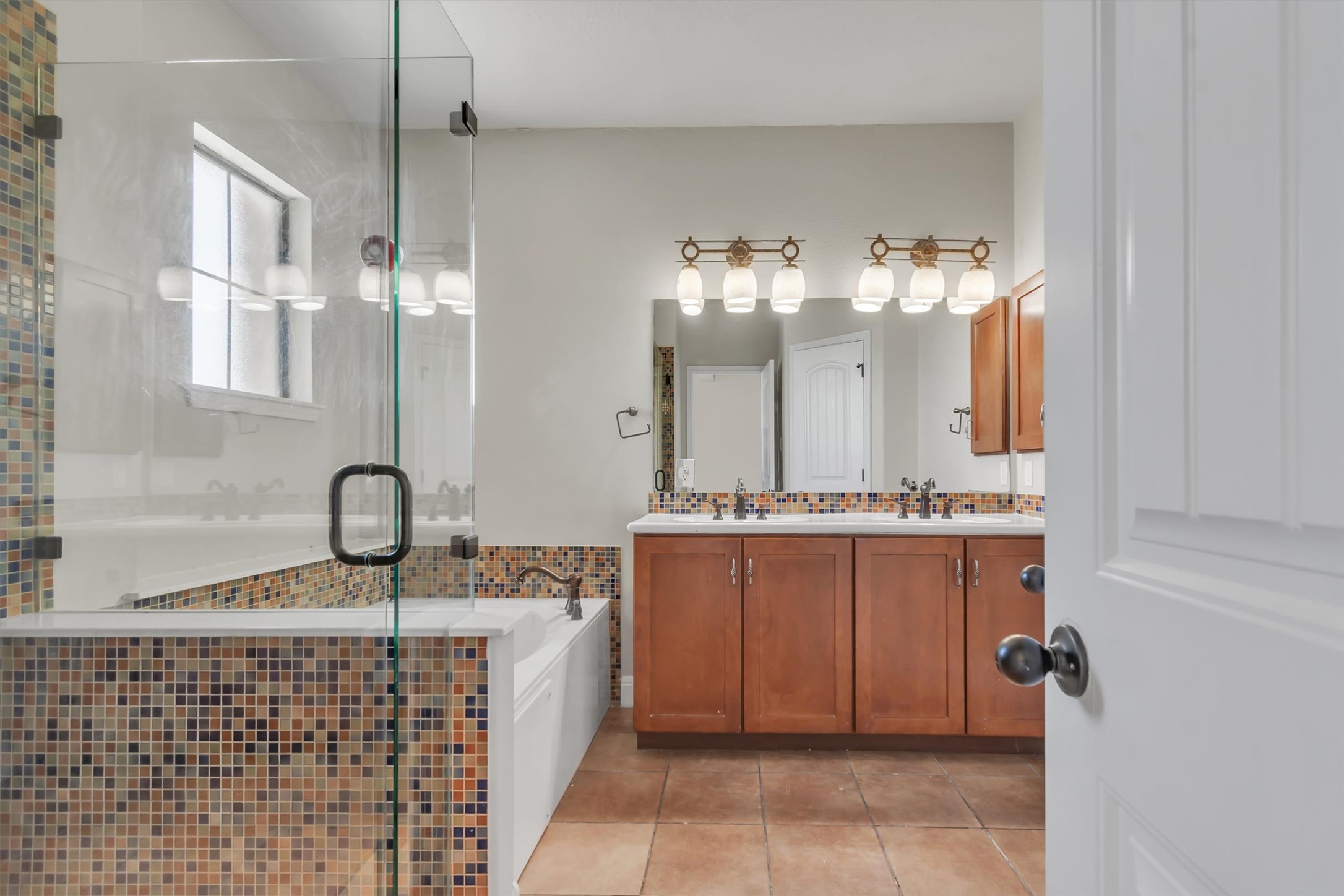1010 Immanuel Road, Unit 103 Pflugerville, TX 78660 - Photo 21 of 30 Indulge in a tranquil primary bathroom featuring a spacious walk-in shower and dual vanities.