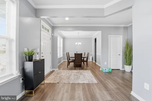 a dining room with furniture and wooden floor