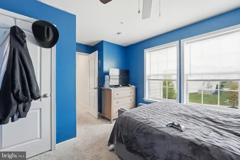 a bedroom with a large bed and a large window