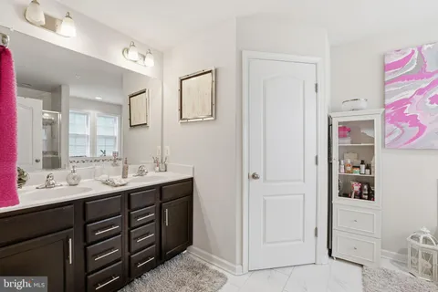 a bathroom with a sink vanity and mirror
