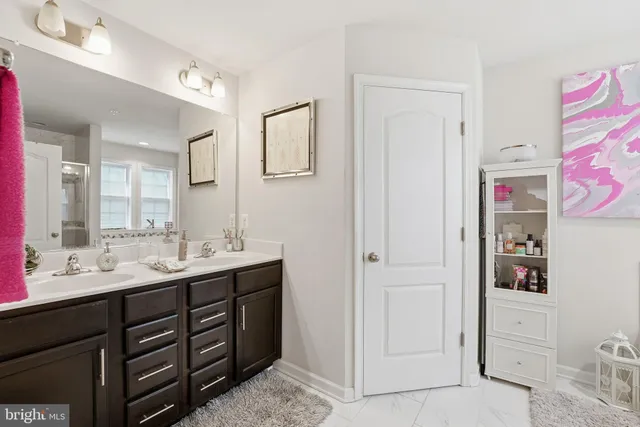 a bathroom with a sink vanity and mirror