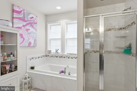 a bathroom with a bathtub and a shower