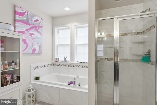 a bathroom with a bathtub and a shower