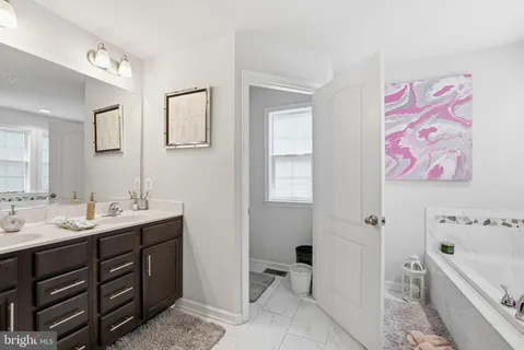 a spacious bathroom with a bathtub sink and toilet