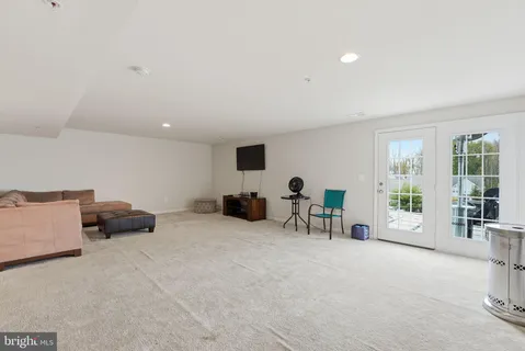a view of a livingroom with furniture and a large window