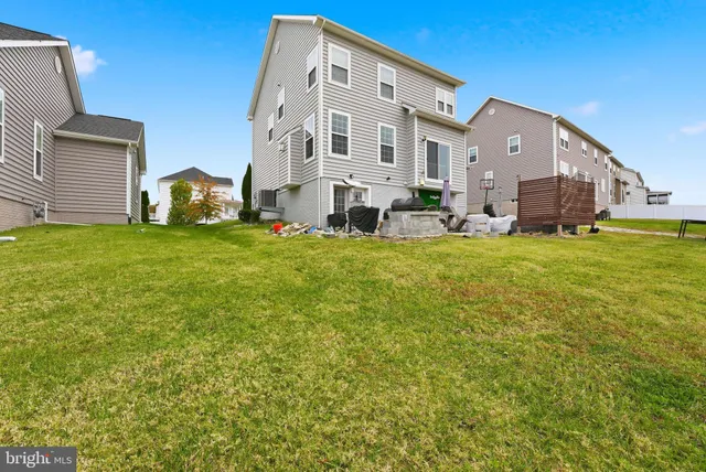 a view of a big house with a big yard and large trees