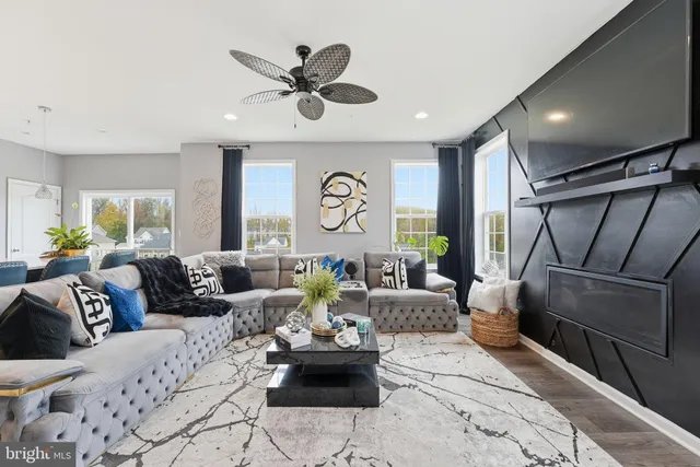 a living room with furniture and a clock