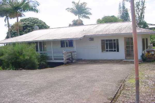 151 Manulele Street Hilo, HI 96720 - Photo 1 of 4 a backyard of a house with plants and palm tree