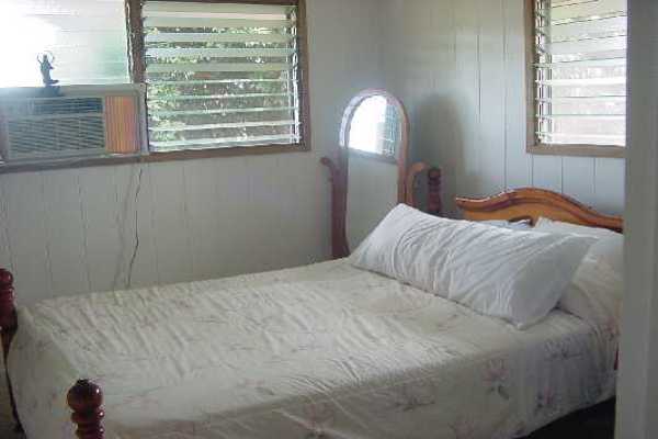 151 Manulele Street Hilo, HI 96720 - Photo 4 of 4 a bedroom with a bed and a window