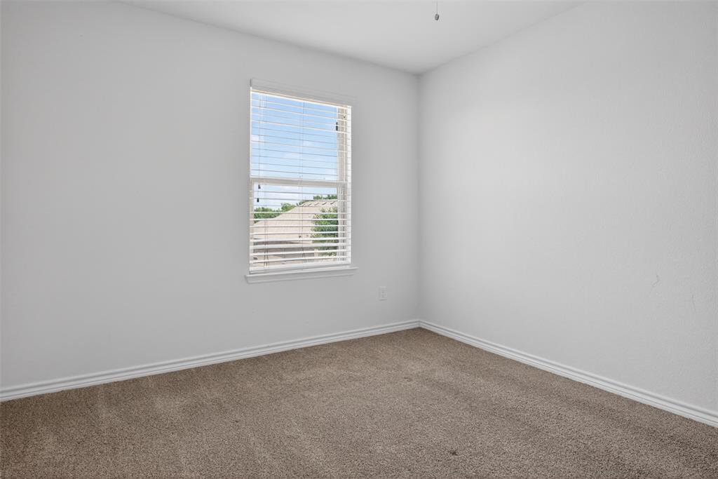 8728 Maple Ridge Trail Fort Worth, TX 76244 - Photo 35 of 40 Carpeted room featuring a single window with blinds, white walls, and white baseboards