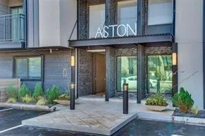 a front view of a building with potted plants