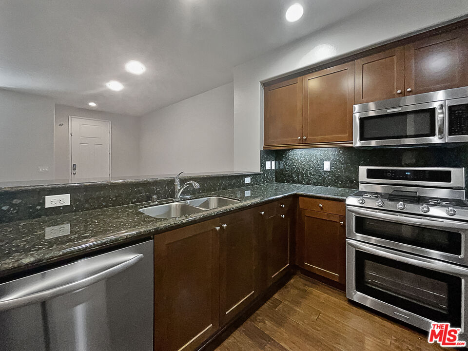 2234 Winifred Street, Unit 3 Simi Valley, CA 93063 - Photo 12 of 21 a kitchen with stainless steel appliances granite countertop a sink and a stove