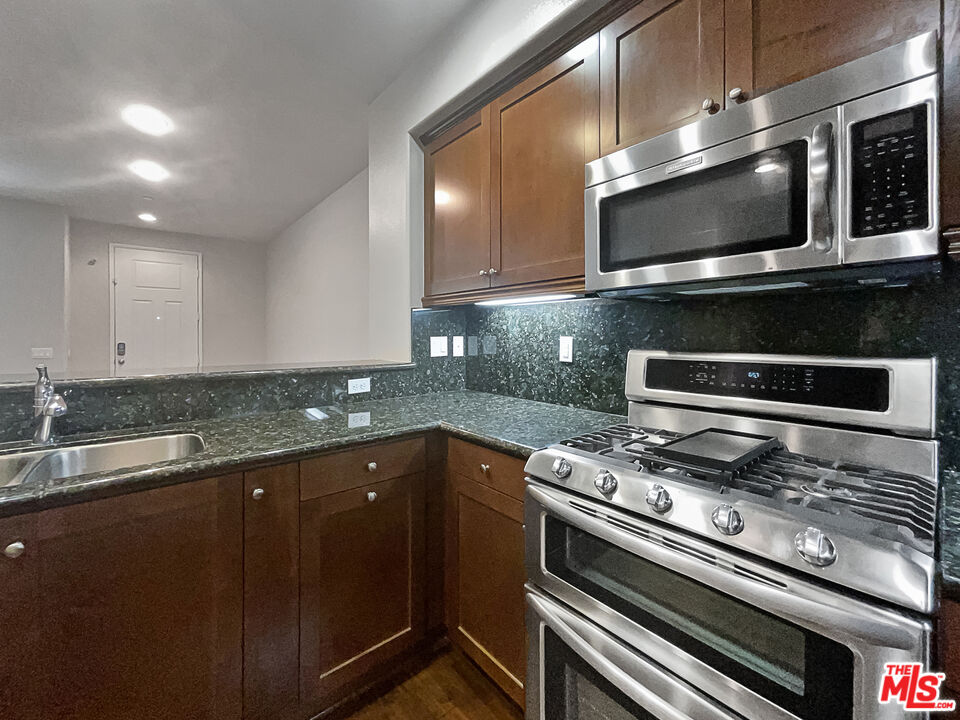 2234 Winifred Street, Unit 3 Simi Valley, CA 93063 - Photo 13 of 21 a kitchen with granite countertop a sink and stainless steel appliances