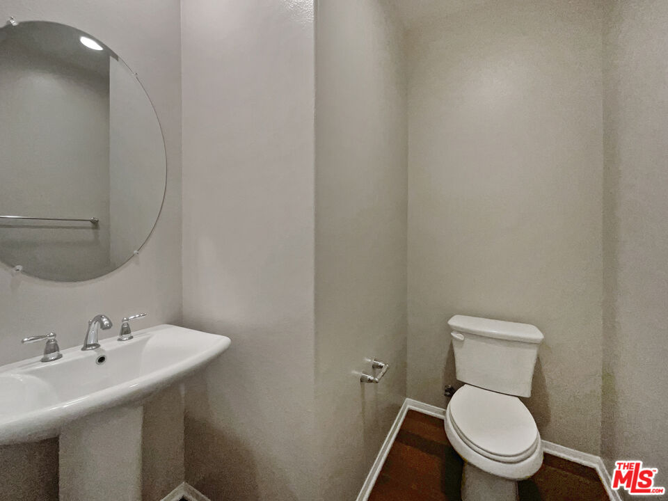2234 Winifred Street, Unit 3 Simi Valley, CA 93063 - Photo 14 of 21 a white toilet sitting next to a bathroom sink
