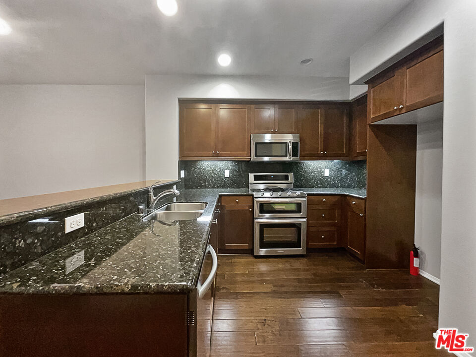 2234 Winifred Street, Unit 3 Simi Valley, CA 93063 - Photo 2 of 21 a kitchen with stainless steel appliances granite countertop a sink stove and refrigerator