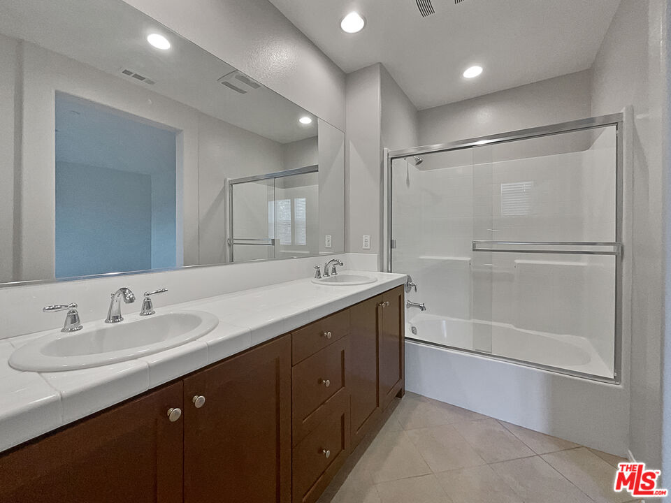 2234 Winifred Street, Unit 3 Simi Valley, CA 93063 - Photo 5 of 21 a bathroom with a double vanity sink mirror and shower