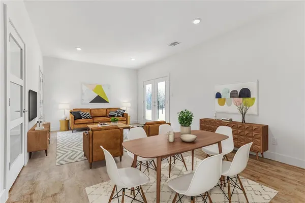 a dining room with furniture and a window