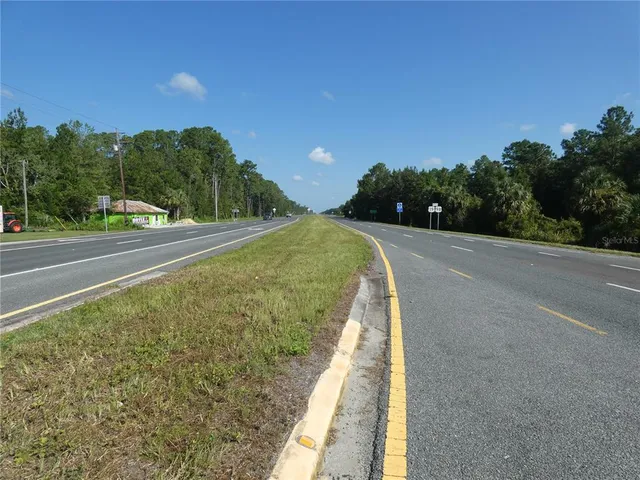 a view of a pathway both side of a road with a yard