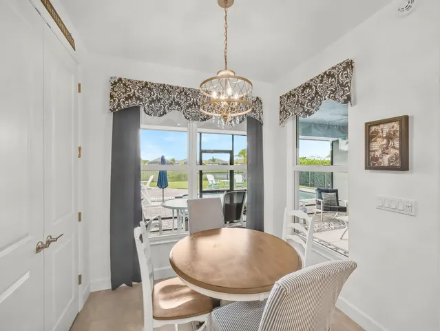 a front view of a house with a garden and trees