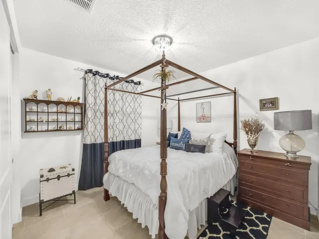 a view of a patio with a table chairs and garden